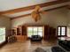 A spacious living room featuring wooden beams, custom built-in shelving, and lots of natural light at 5900 Leeland S St, St Petersburg, FL 33715