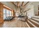Bright living room featuring high ceilings, wooden beams, and beautiful wood floors at 5900 Leeland S St, St Petersburg, FL 33715