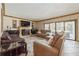 Inviting living room featuring a fireplace, plush seating, and natural light from sliding glass doors at 5900 Leeland S St, St Petersburg, FL 33715