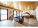 Spacious main bedroom featuring wood floors, a wooden ceiling, and large windows for natural light at 5900 Leeland S St, St Petersburg, FL 33715