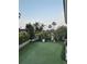 Relax in the backyard with putting green, bench, privacy landscaping and gate to more outdoor space at 5900 Leeland S St, St Petersburg, FL 33715