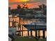 Waterfront property showcasing a boat dock with views of the sunset, docks, and boats at 5900 Leeland S St, St Petersburg, FL 33715