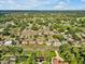 Ariel shot showing a neighborhood's proximity to amenities and a vast canopy of trees at 909 Kirkcaldy Way, Valrico, FL 33594