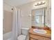 Clean bathroom with shower and wooden vanity at 909 Kirkcaldy Way, Valrico, FL 33594