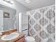 Modern bathroom featuring decorative shower curtain and wood vanity at 909 Kirkcaldy Way, Valrico, FL 33594