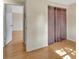 Bedroom featuring laminate floors, closet, and an open door at 909 Kirkcaldy Way, Valrico, FL 33594