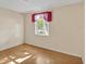 Bright bedroom featuring hardwood floors and a large window at 909 Kirkcaldy Way, Valrico, FL 33594