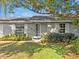 Close-up of home's front door with white trim, windows, and a well-kept lawn at 909 Kirkcaldy Way, Valrico, FL 33594