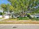 Charming single-story home featuring a well-manicured lawn and mature trees at 909 Kirkcaldy Way, Valrico, FL 33594