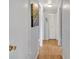 Well-lit hallway with laminate flooring and white doors at 909 Kirkcaldy Way, Valrico, FL 33594