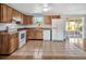 Updated kitchen featuring a tile floor, white appliances, and access to the patio at 909 Kirkcaldy Way, Valrico, FL 33594