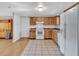 Well-lit kitchen features tile floors, white appliances and wooden cabinets at 909 Kirkcaldy Way, Valrico, FL 33594