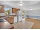 Sunlit kitchen with wood cabinets and white appliances at 909 Kirkcaldy Way, Valrico, FL 33594