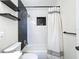 Updated bathroom with white subway tile, black accent wall, and modern shower fixtures at 1121 49Th Ave N, St Petersburg, FL 33703