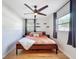 Inviting bedroom with hardwood floors, ceiling fan, and stylish bed with modern decor at 1121 49Th Ave N, St Petersburg, FL 33703