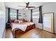 Comfortable bedroom featuring a modern bed frame, wood floors, and large windows with curtains at 1121 49Th Ave N, St Petersburg, FL 33703