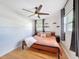 Charming bedroom featuring a modern ceiling fan, wood floor, and natural light at 1121 49Th Ave N, St Petersburg, FL 33703