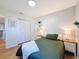 Bright bedroom with hardwood floors, double closet, and decorative shelving at 1121 49Th Ave N, St Petersburg, FL 33703