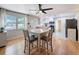 Open concept dining area that flows into a kitchen, filled with natural light from a large window at 1121 49Th Ave N, St Petersburg, FL 33703