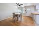 Bright dining area featuring hardwood floors, a ceiling fan, and a view to the front yard at 1121 49Th Ave N, St Petersburg, FL 33703