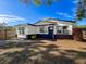A well-maintained single-story home with a modern design and well-manicured lawn on a clear, sunny day at 1121 49Th Ave N, St Petersburg, FL 33703