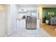 Kitchen featuring stainless steel refrigerator, updated white cabinets, butcher block countertops and marble tile floors at 1121 49Th Ave N, St Petersburg, FL 33703