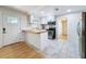 Updated kitchen with marble floors, stainless steel appliances, butcher block countertops, and white cabinets at 1121 49Th Ave N, St Petersburg, FL 33703