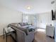 Spacious living room with gray sectional, accent pillows, and bright natural light from windows at 1121 49Th Ave N, St Petersburg, FL 33703
