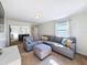 Bright living room featuring a comfortable gray sectional sofa and ample natural light at 1121 49Th Ave N, St Petersburg, FL 33703