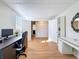 Open office space with hardwood floors, built-in shelving, and a neutral palette at 1121 49Th Ave N, St Petersburg, FL 33703