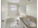 Clean bathroom featuring a shower-tub combo and a neutral color palette at 11823 Derbyshire Dr, Tampa, FL 33626