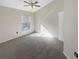 Bright bedroom features include a ceiling fan, neutral carpet, and a window providing natural light at 11823 Derbyshire Dr, Tampa, FL 33626