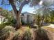 Charming single-story home surrounded by mature landscaping, providing a serene curb appeal at 11823 Derbyshire Dr, Tampa, FL 33626