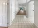 Bright hallway leading to a spacious living area with tile flooring and ample closet space at 11823 Derbyshire Dr, Tampa, FL 33626