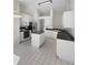 Spacious kitchen with white cabinets, black appliances, and an island, offering plenty of counter space at 11823 Derbyshire Dr, Tampa, FL 33626
