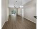 Large living room featuring hardwood floors and sliding glass doors leading to the screened-in lanai at 11823 Derbyshire Dr, Tampa, FL 33626
