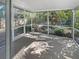 Screened-in patio overlooking a fenced-in backyard with lush greenery at 11823 Derbyshire Dr, Tampa, FL 33626
