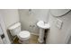 Powder room features pedestal sink, toilet, framed mirror, and neutral paint at 9509 Citrus Glen Pl # 11, Tampa, FL 33618