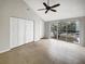 Bedroom featuring tile flooring, a ceiling fan, and sliding glass doors to a balcony at 9509 Citrus Glen Pl # 11, Tampa, FL 33618