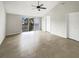 Bedroom featuring tile floors, ceiling fan, and sliding doors to a balcony with black railings at 9509 Citrus Glen Pl # 11, Tampa, FL 33618