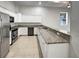 Bright kitchen with white cabinetry, granite countertops, stainless steel appliances, and tile flooring at 9509 Citrus Glen Pl # 11, Tampa, FL 33618