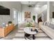 Bright living room features contemporary decor with a neutral palette, tile flooring, and an open staircase at 9509 Citrus Glen Pl # 11, Tampa, FL 33618