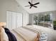 Spacious main bedroom with a ceiling fan, balcony access, and a large closet with double doors at 9509 Citrus Glen Pl # 11, Tampa, FL 33618