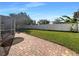 A backyard featuring a brick paver patio, lawn, and fence at 2317 Valrico Forest Dr, Valrico, FL 33594