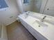 This bathroom features double sinks and quartz countertops at 2317 Valrico Forest Dr, Valrico, FL 33594