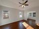 Bedroom featuring hardwood floors, ceiling fan, and ample natural light streaming through the windows at 2317 Valrico Forest Dr, Valrico, FL 33594