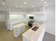 Bright kitchen with white cabinets, stainless steel appliances, a center island, and lots of recessed lights at 2317 Valrico Forest Dr, Valrico, FL 33594