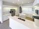 Modern kitchen features white cabinets, stainless steel appliances, a center island, and quartz countertops at 2317 Valrico Forest Dr, Valrico, FL 33594