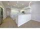 Open kitchen features white cabinets, stainless steel appliances, a breakfast bar, and tiled flooring at 2317 Valrico Forest Dr, Valrico, FL 33594