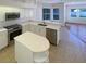Modern kitchen featuring stainless steel appliances, white cabinets, a center island, and lots of space at 2317 Valrico Forest Dr, Valrico, FL 33594
